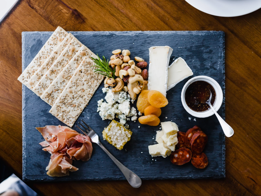 charcuterie board with crackers, meats and cheeses